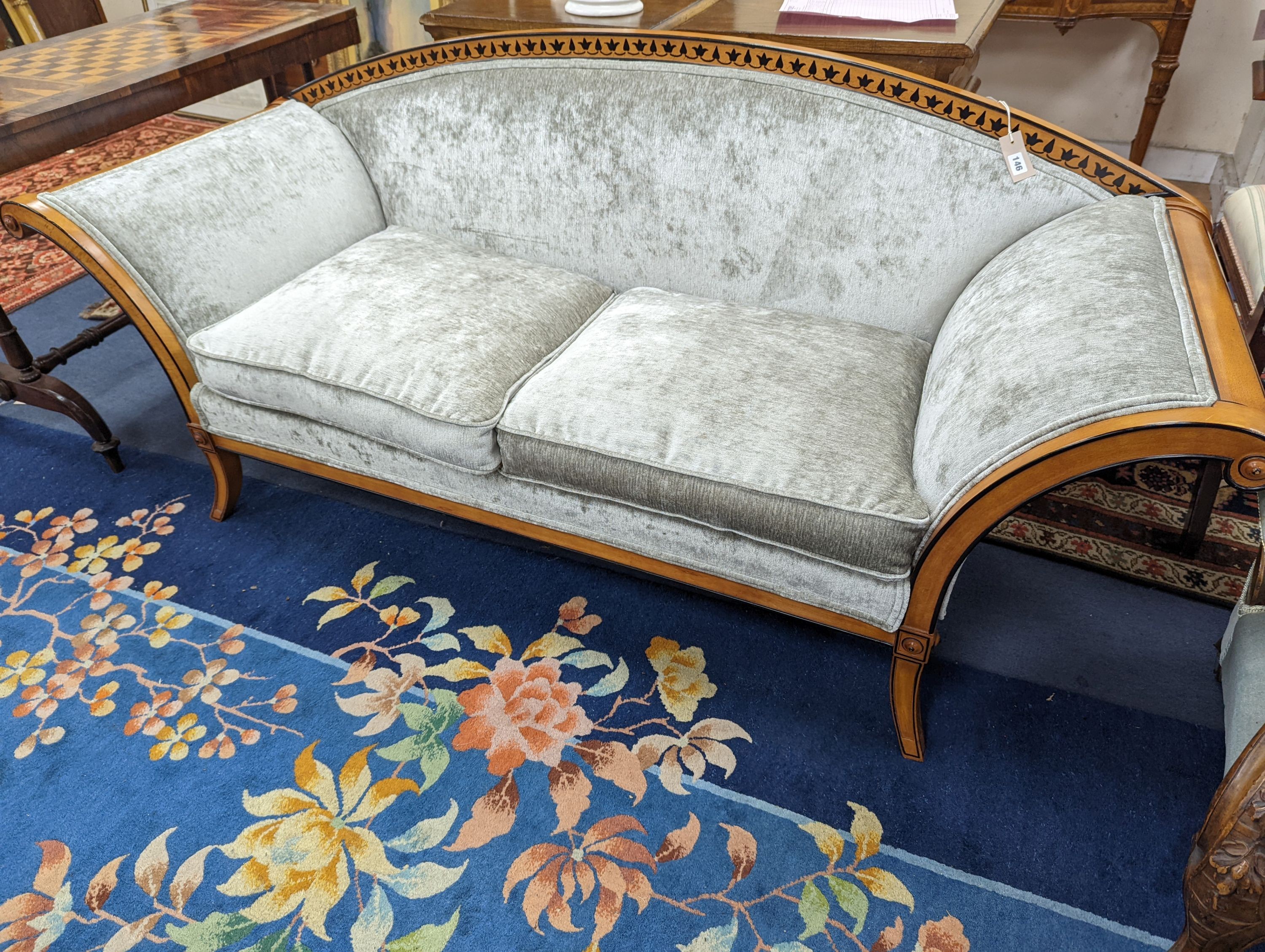 A 19th century Biedermier style part ebonised two seater scroll arm settee recently upholstered in grey velvet, length 180cm, depth 63cm, height 79cm